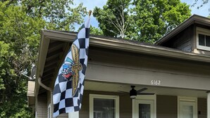 A house with a porch, a flag, and a mailbox. - Broad Ripple 1 Bedroom  (Indianapolis)
