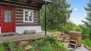 A rustic cabin with a red door, a stone-paved entrance, and a wooden sauna. - Roubenka Maleč by Interhome (Nezdice na Šumavě)