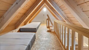 A small attic bedroom with two single beds, wooden beams, and a sloped ceiling. - Roubenka Maleč by Interhome (Nezdice na Šumavě)