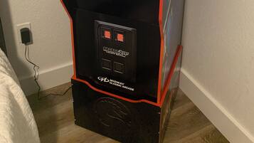 A Midway arcade machine for Mortal Kombat II, featuring a classic design with red accents and a display screen.