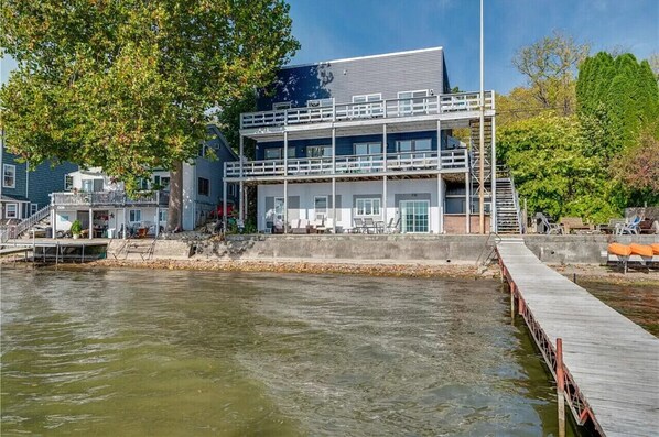 A waterfront building with a dock, a staircase, and a view of the water.