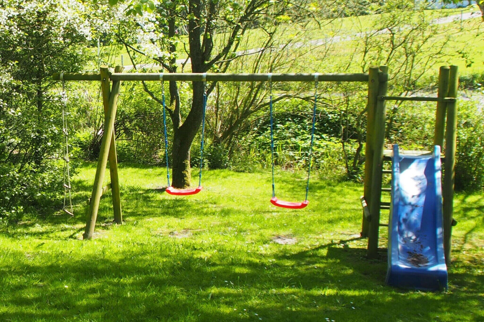 A playground with swings and a slide.