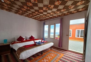 A room with a bed, a window, and a view of the outside. - Blue Chill Cottage Pangong (Leh)