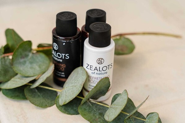 Three bottles of Zealots of Nature body wash with eucalyptus leaves around them. - Kastro Suite in Naxos Old Town (Naxos)