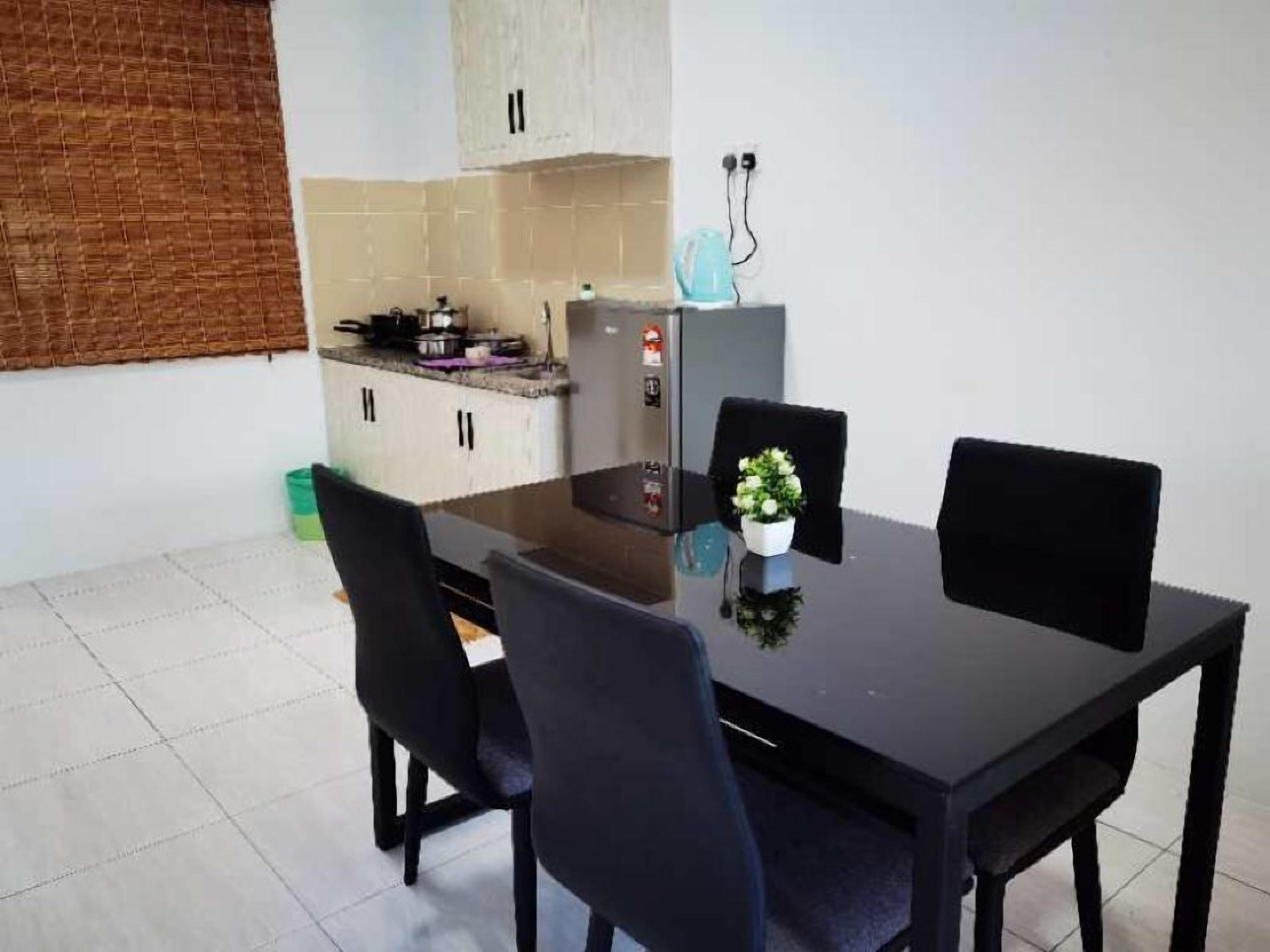 A compact kitchen with a dining area.