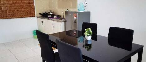 A compact kitchen with a dining area.
