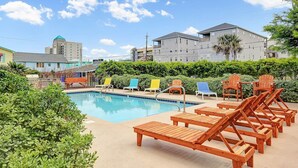 A pool area with lounge chairs and a clear blue sky. - Do you want to go to the beach "Oar Knot"? (Carolina Beach)