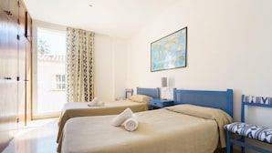 A hotel room with two beds, a map on the wall, and a view of the outside. - Pine Walk Xisco apartment by Vida Villas (Pollença)