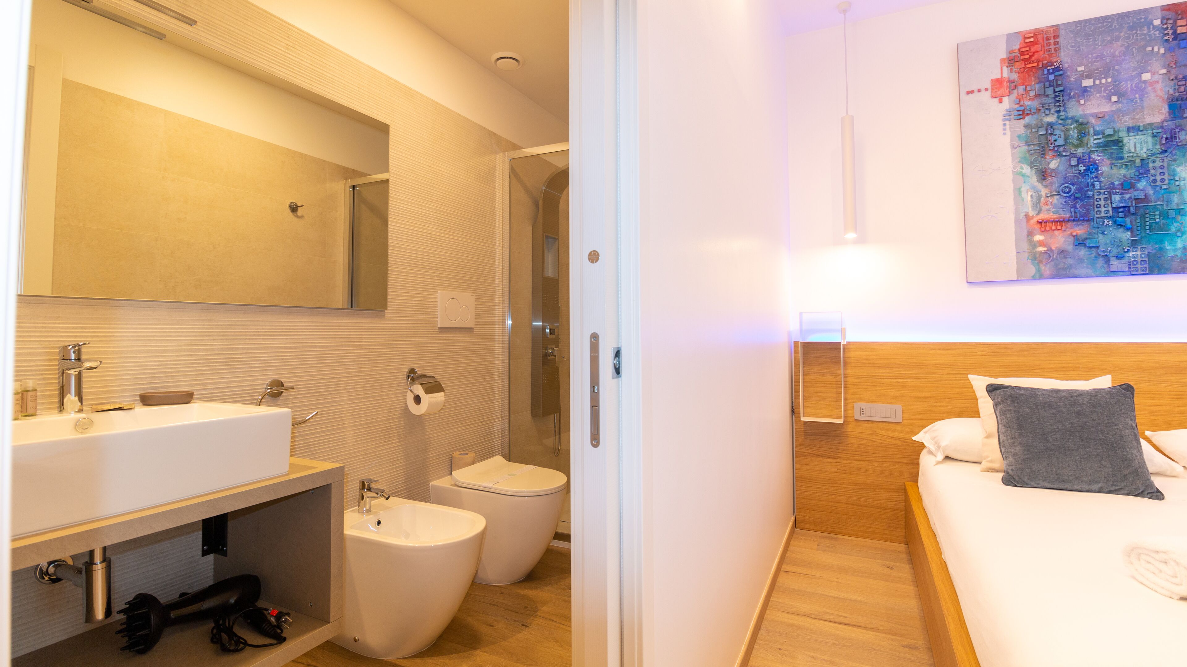 A modern bathroom with a sink, toilet, and shower.
