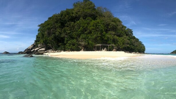 A beach with clear turquoise water, a small sandy island with a gazebo, and lush green vegetation. - The Beachaven Chalets Kota Belud (Kota Belud)