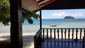 A wooden deck with a view of a beach and ocean. - The Beachaven Chalets Kota Belud (Kota Belud)