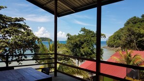 A balcony with a view of the sea and a distant island. - The Beachaven Chalets Kota Belud (Kota Belud)