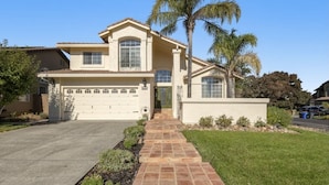 A two-story house with a garage, a front porch, and a well-maintained lawn. - Beautiful Home in Northwest Napa

 (Napa)