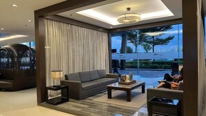 A modern living room with a sofa, coffee table, and lamp. - Shore One condotel at Mall of Asia, Pasay City Manila Philippines  (Pasay)