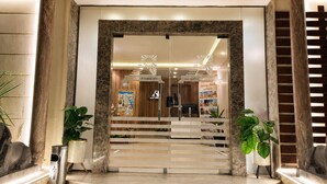 A grand entrance with a marble staircase, a reception desk, and a view of the interior. - Aziz Egypt Pyramids Hotel (Giza)