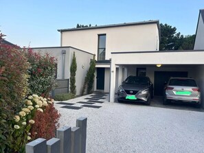 Stylish two-story residence with a garage and garden area.