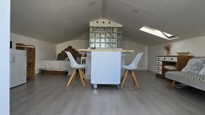 Ett modernt boende i loftstil med matplats, sovloft och kök.