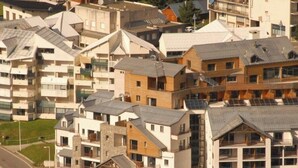 A residential area with multi-story buildings, some with visible balconies and solar panels.