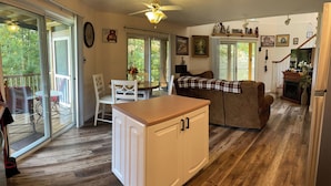 A spacious kitchen with a central island, a dining area with a table and chairs, and a cozy living area with a couch. - Majestic, three bedroom mountaintop vacation retreat! Pet friendly! (Topton)