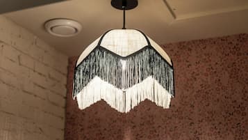 A pendant light with a fringed design hanging from the ceiling.