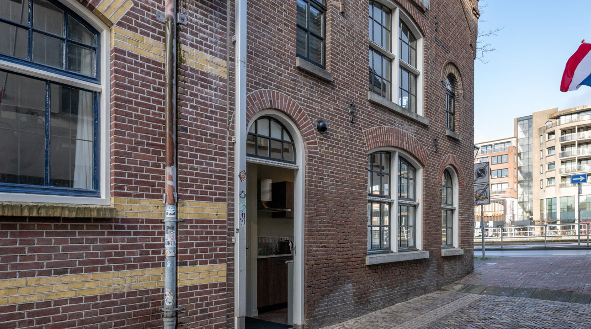 A brick building with a private entrance directly from the street.