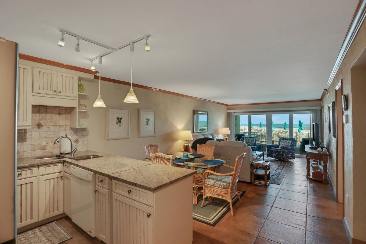 Open floor plan features an updated kitchen, with wonderful views looking straight out over the pool and the ocean