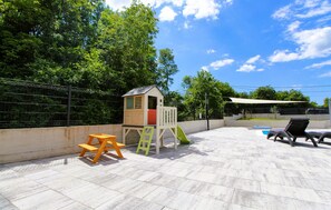 A children's play area with a slide, a small playhouse, and a picnic table. - Beautiful home in Labin (Labin)