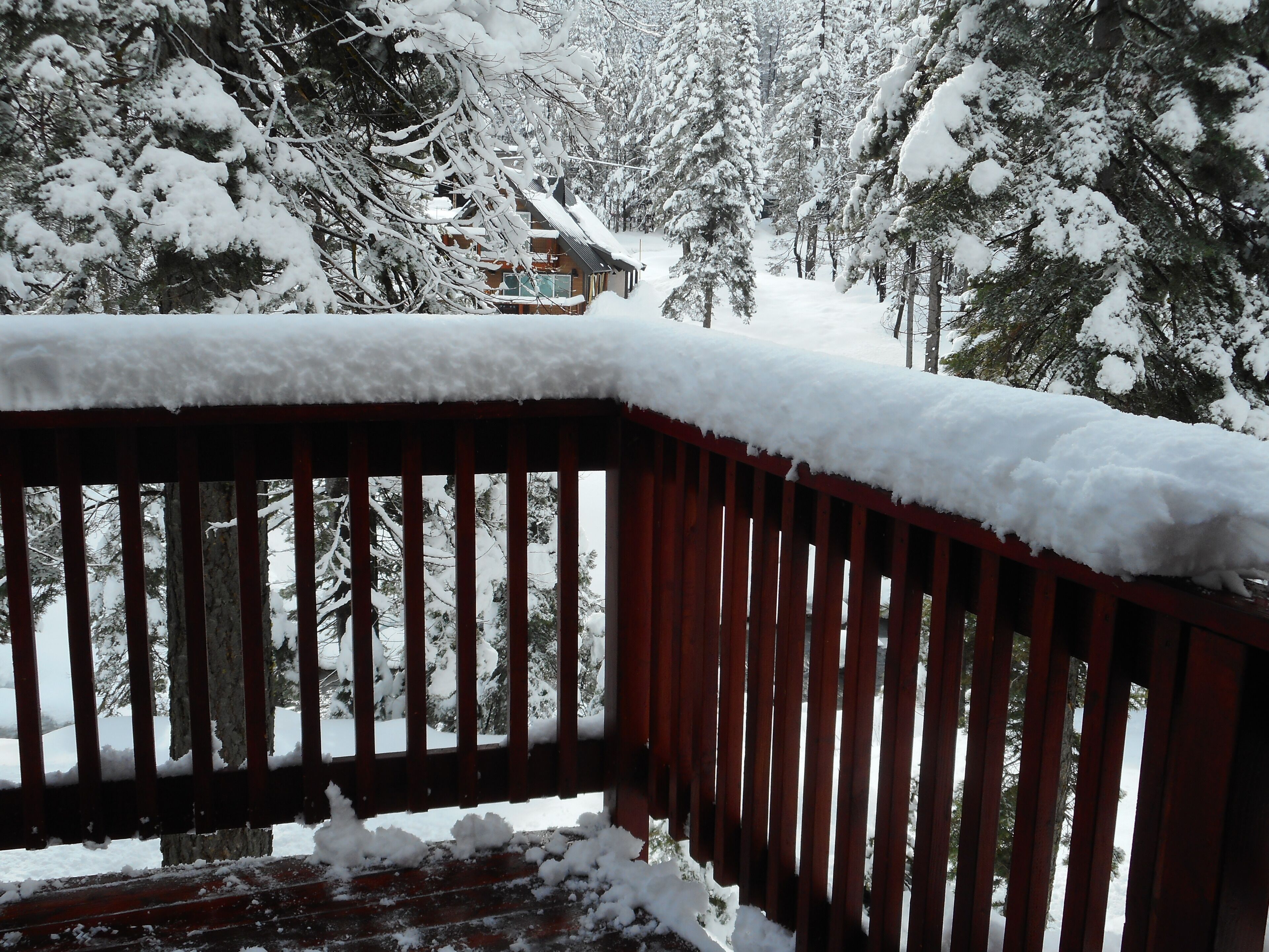 Eine Holzterrasse mit Schneebedeckung.