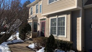 A two-story house with a brick pathway and snow accumulation around the foundation. - Saratoga retreat!  Great yard with inground pool.  4 miles from Racetrack. (Saratoga Springs)