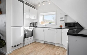 Fridge, stovetop, dishwasher, coffee/tea maker