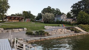 A lakeside park with a gazebo, picnic tables, and a stone pathway leading to a dock. - Park model unit #2 for rent by Silver Lake NY  (Perry)