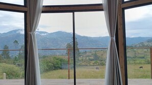 A room with large windows, wooden flooring, and curtains. - Glamping Caelum, Refugio al Aire Libre. Macheta Cundinamarca (Machetá)
