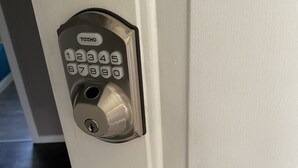 A door with a modern electronic lock and a lever handle. - Quiet cozy room no stairs in a peaceful house, safe community, full kitchen (Langley Township)