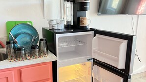 A compact kitchen with a microwave, toaster, coffee maker, and a refrigerator. - Private Suite with Washer and Dryer, Kitchenette  and Enclosed Parking (Las Cruces)