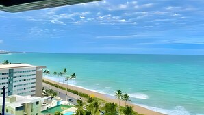 A coastal hotel with a view of the ocean and beach.