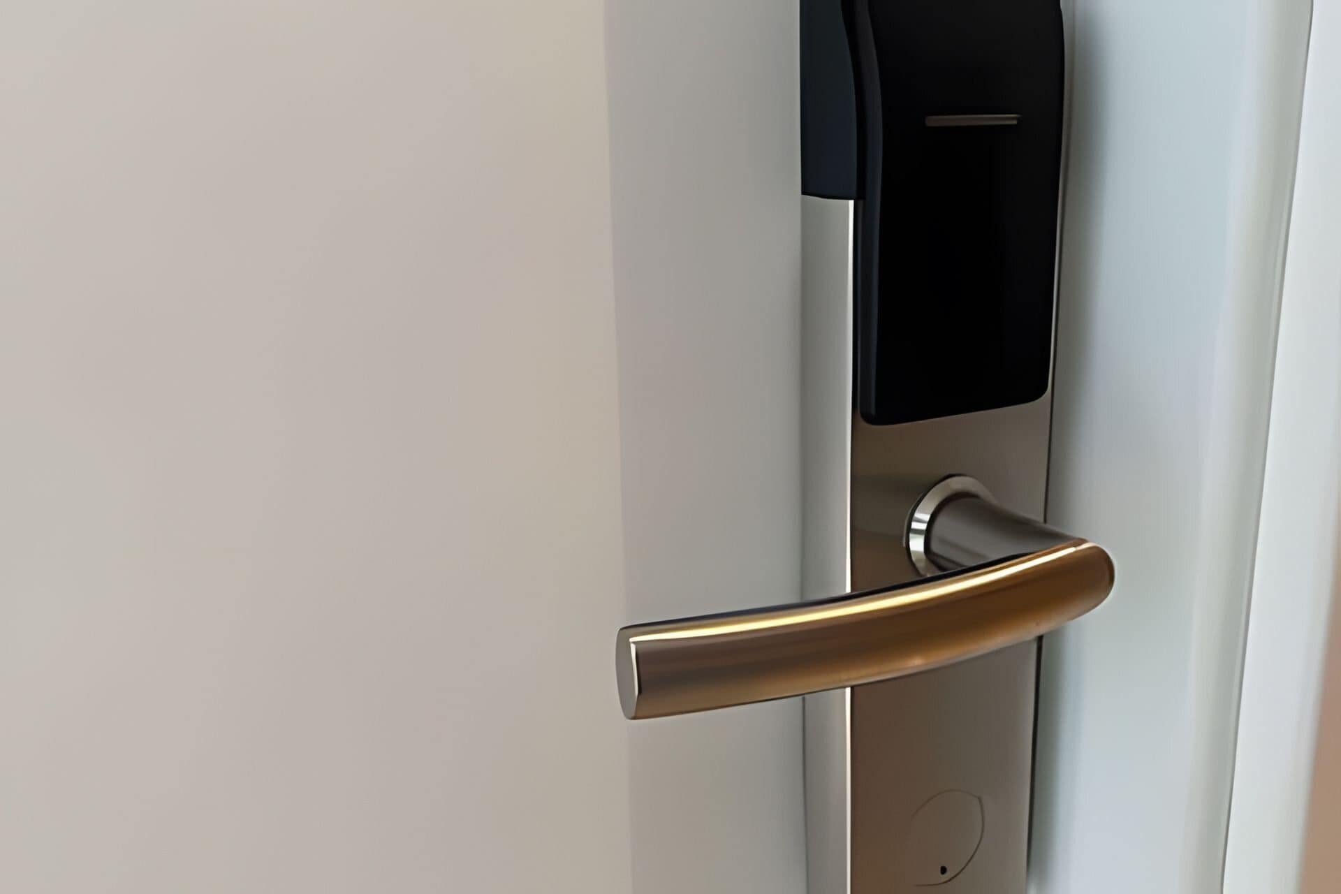 A modern door handle with a sleek, metallic finish.