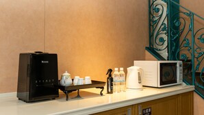 A kitchenette with a coffee maker, microwave, and a water dispenser. - Higashi Kumamoto Business Center (Ozu)