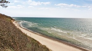 A coastal road with a sandy beach and ocean waves. - "Herlek" - 450m from the sea by Interhome (Aakirkeby)