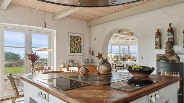 A spacious kitchen with a large island, wooden countertops, and a stainless steel range hood. - "Herlek" - 450m from the sea by Interhome (Aakirkeby)