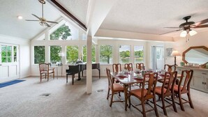 A spacious dining area with a piano, wooden chairs, and a table set for six. - Great for Traveling Work Teams /20-30 minutes to downtown Atlanta/Sleeps 12/Private Pool (Jonesboro)