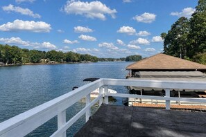 A waterfront property with a dock, a covered area, and a view of the water and trees. - Great for Traveling Work Teams /20-30 minutes to downtown Atlanta/Sleeps 12/Private Pool (Jonesboro)
