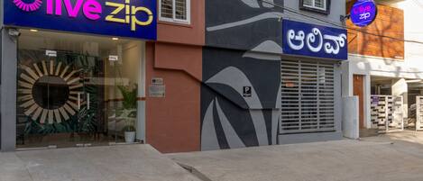 A building with a 'live zip' sign, a glass entrance, and a 'P' parking sign.