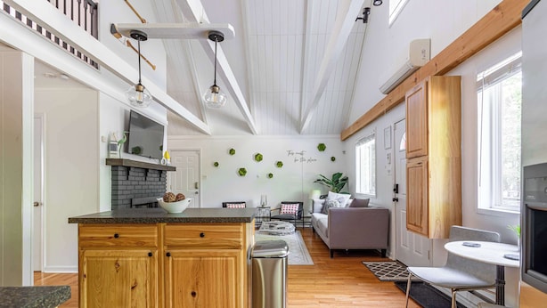 A modern kitchen with wooden cabinets, a central island, and a built-in oven. - Stag Chalet: Summer Retreat | 3BD | Pet Friendly (Albrightsville)