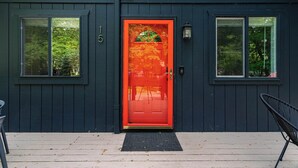 A dark blue building with a red door, numbered 15, and two windows. - Stag Chalet: Summer Retreat | 3BD | Pet Friendly (Albrightsville)