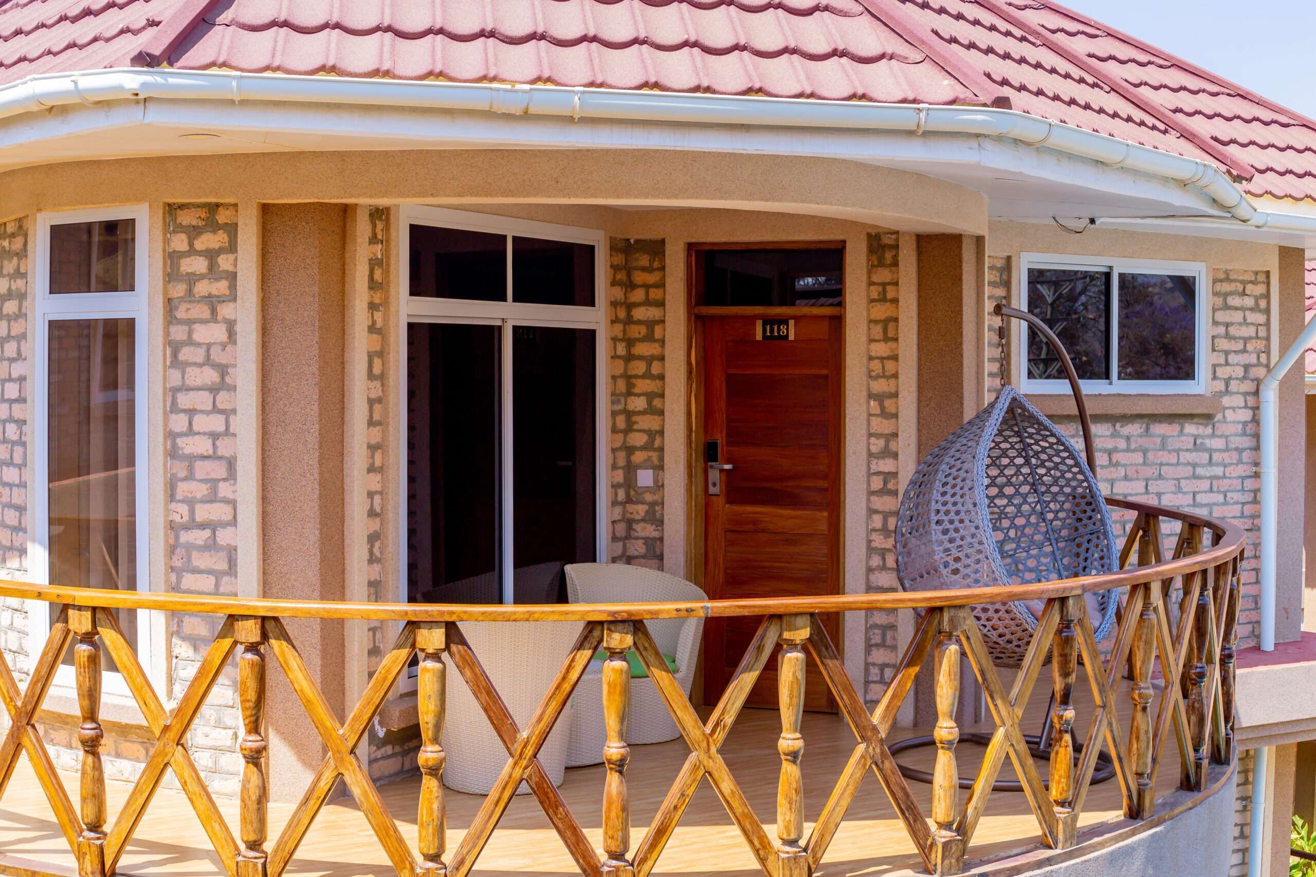 A house with a balcony, a wooden door, and a window.
