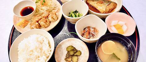 A tray with various dishes including rice, soup, and different types of food.