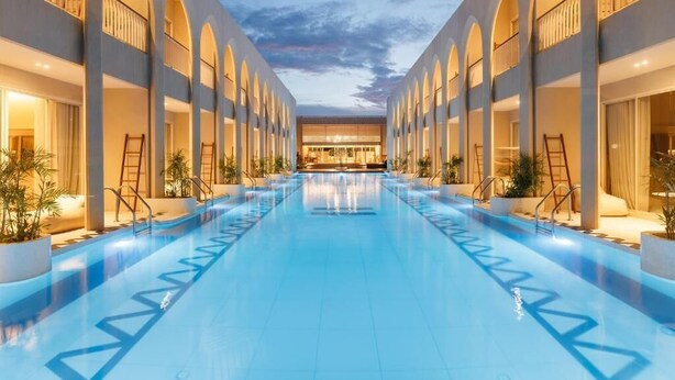 A hotel with a central swimming pool, multiple balconies, and a modern architectural design. - Navakiri Boutique Resort Satun (Satun)