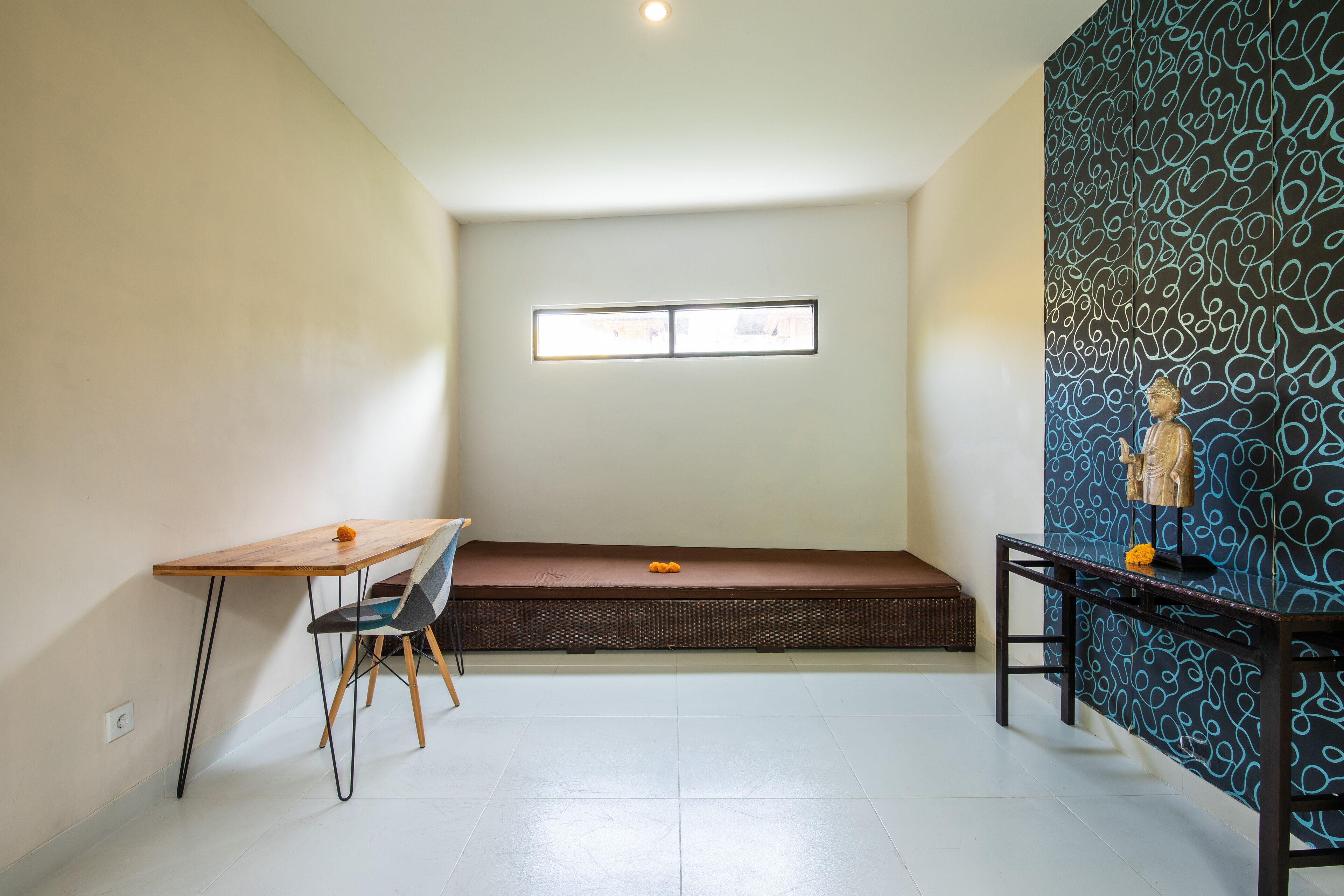 A room with a wooden table, a bench, and a patterned wall.