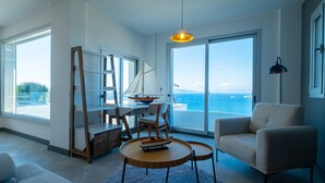 A spacious living room with a large window overlooking the sea, a round wooden table, a sailboat model, and a modern chair. - Villa Valentino 1 (Bodrum)