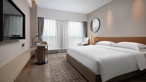A modern hotel room with a large bed, a desk with a lamp, a chair, and a large window with curtains. - Leeden Hotel Hangzhou (Hangzhou)